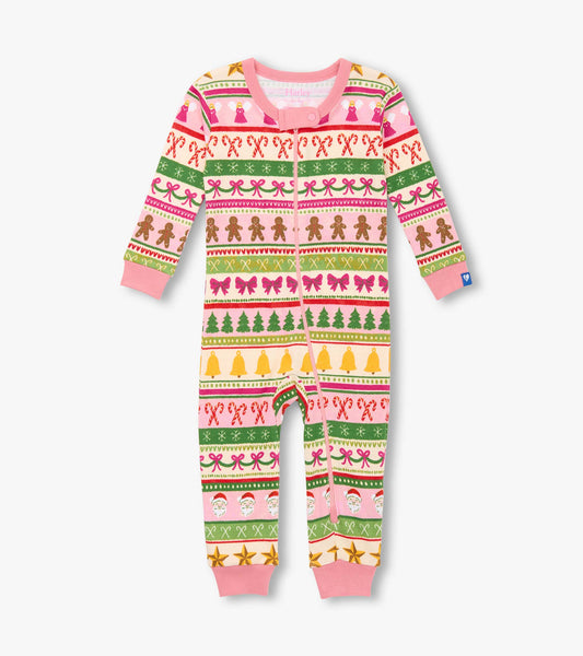 Pink cotton sleeper featuring a fun Fair Isle pattern with gingerbread, bows, trees, and festive motifs.