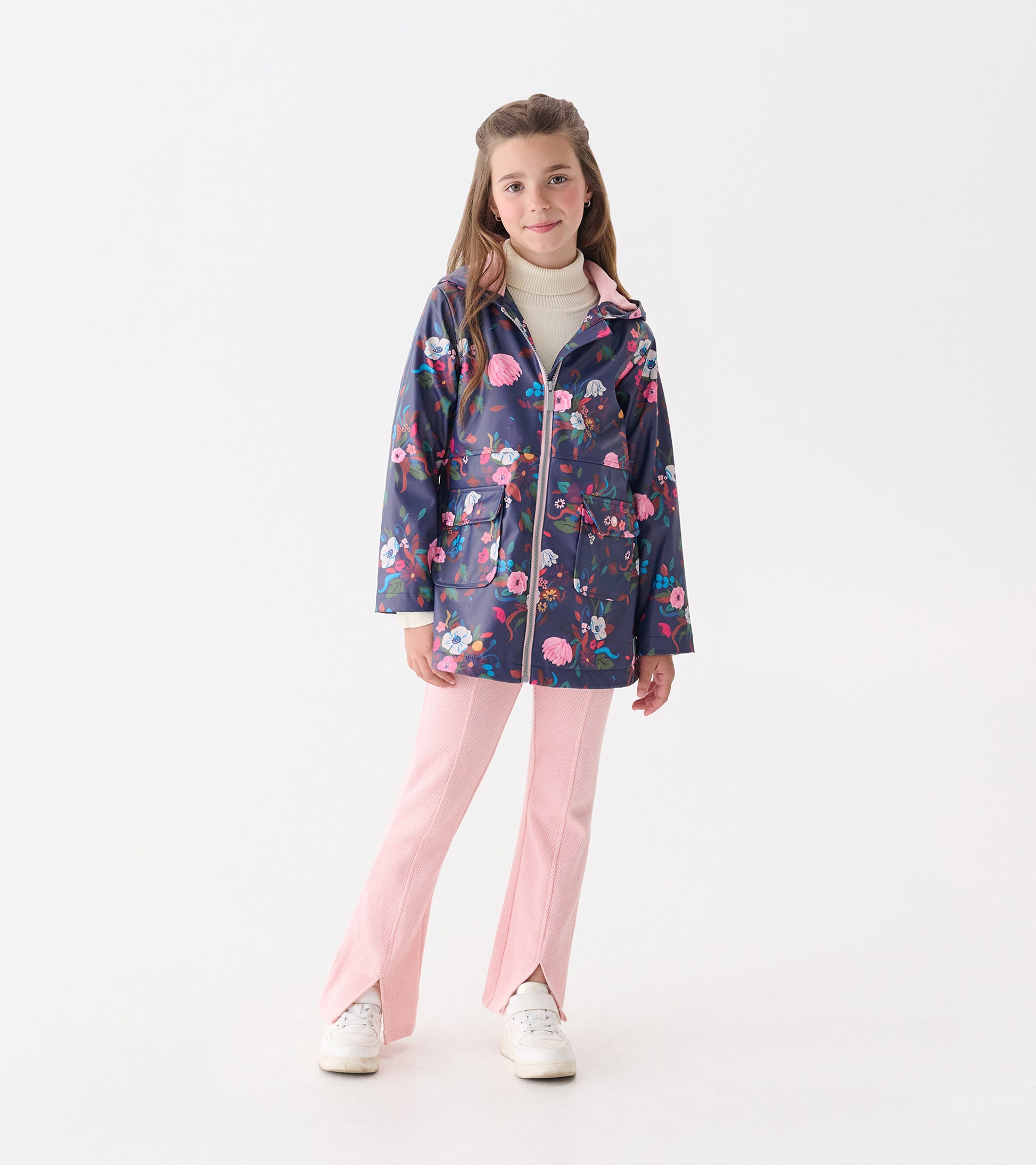 Navy floral zip-up rain jacket with a hood, featuring pink accents and two front pockets, worn over pink pants.