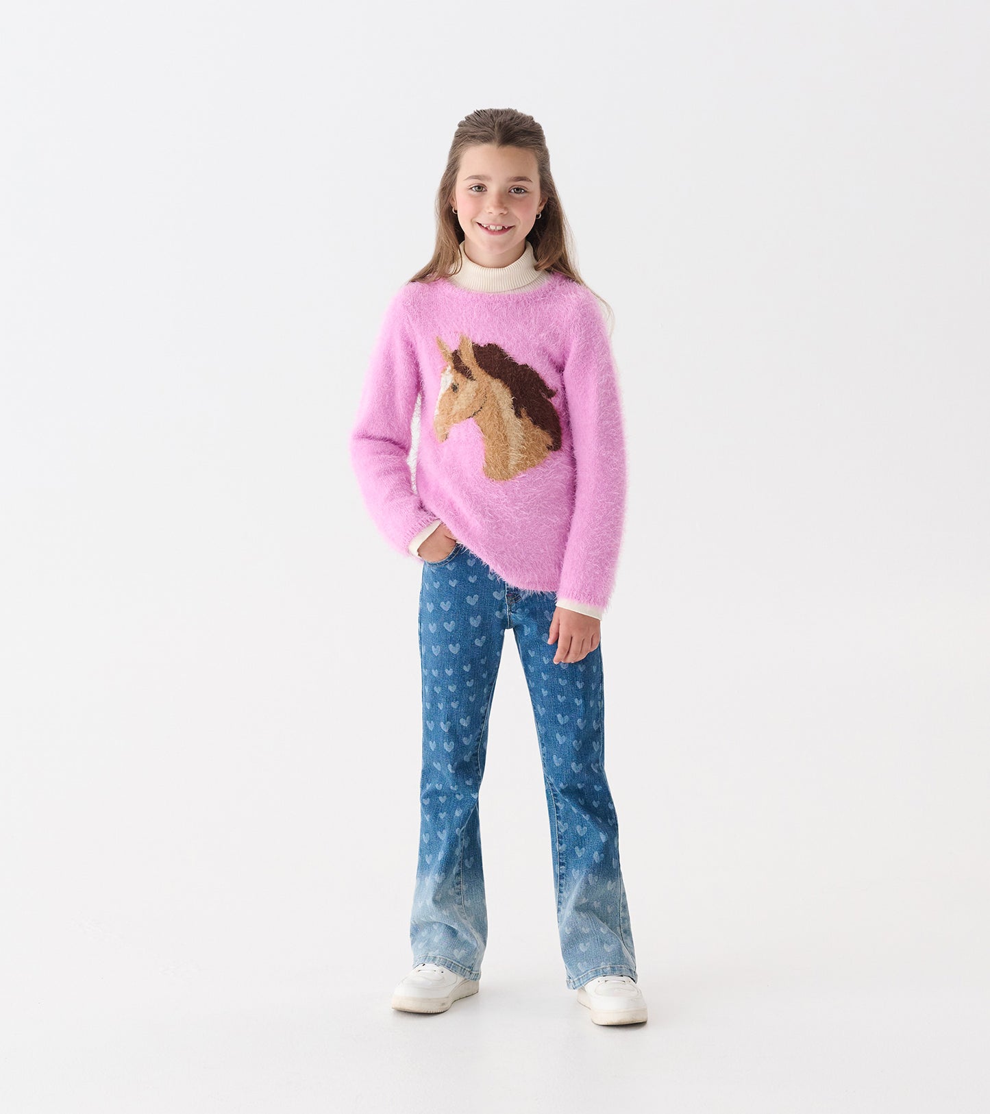 Pink fuzzy sweater featuring a horse design, paired with blue heart-patterned jeans. Suitable for girls.