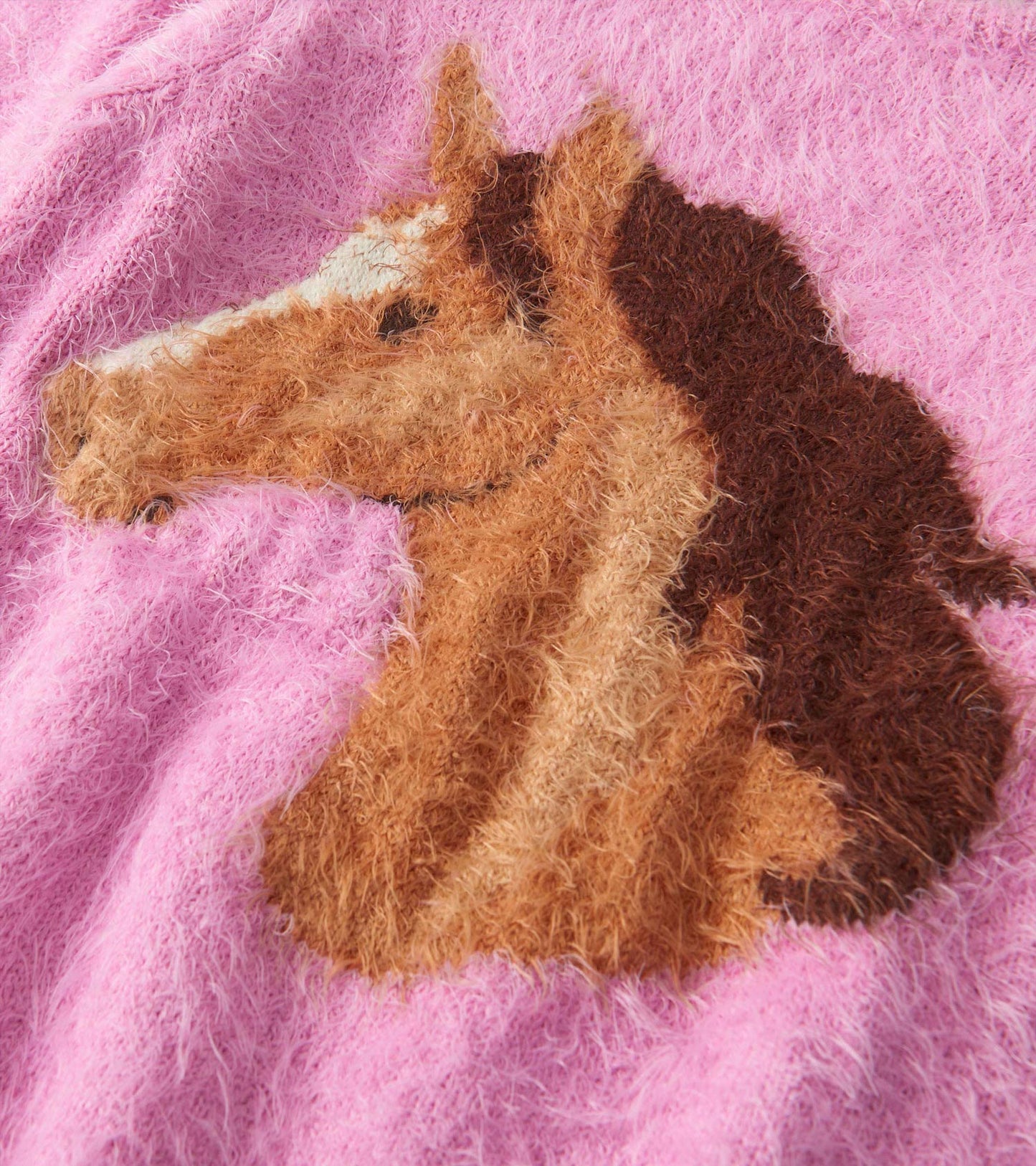 Furry pink sweater featuring a textured horse head design in brown and cream. Soft and cozy for girls.