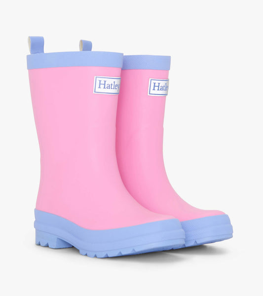 Fuchsia matte rain boots with blue soles and trim, featuring a pull tab for easy wear. Ideal for wet weather.