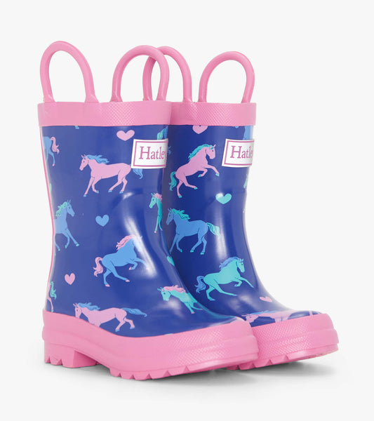 Blue rain boots with pink soles and handles, featuring colorful unicorn and heart patterns. Ideal for toddlers.
