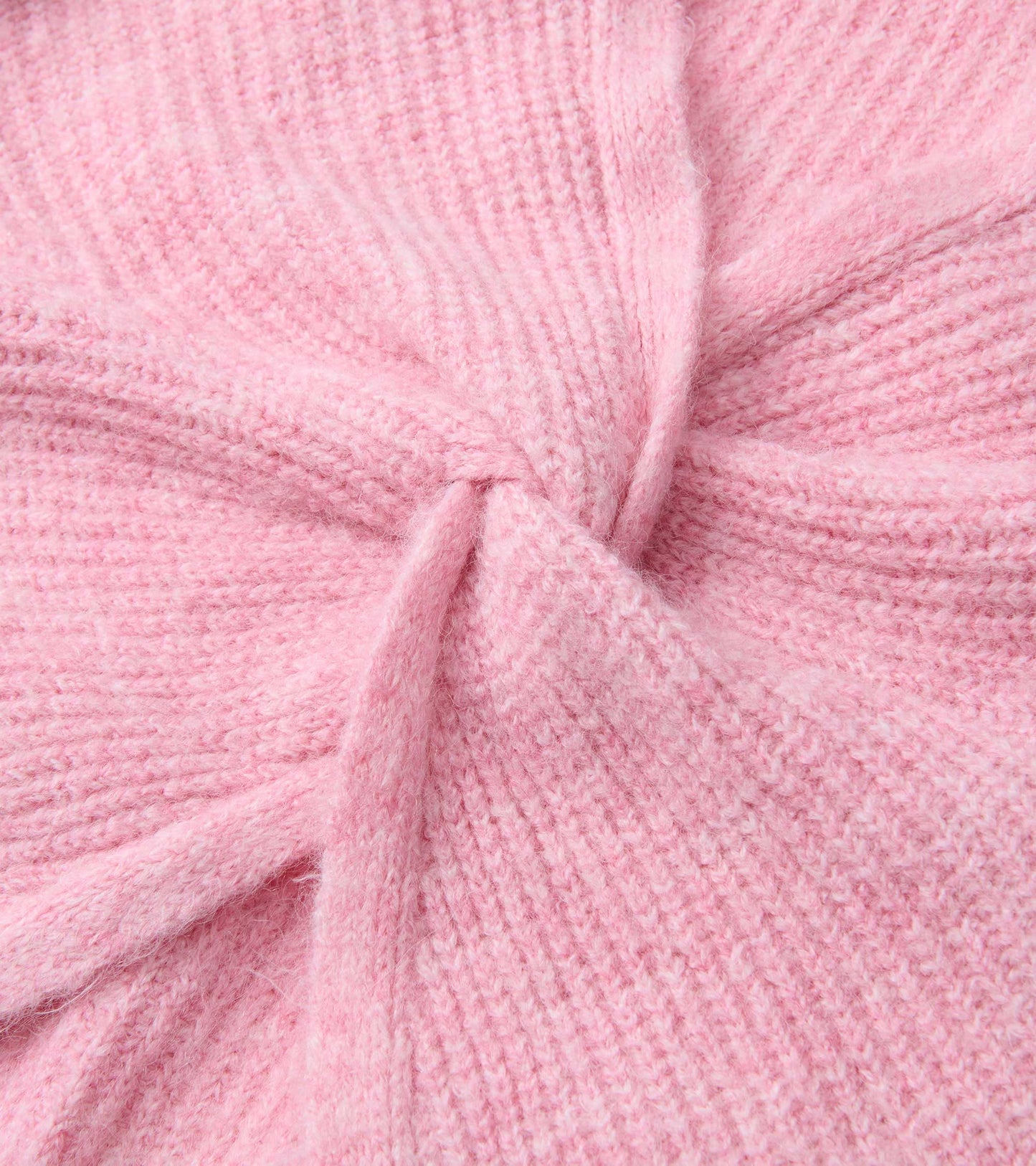 Close-up of a pastel pink knit sweater with a soft textured cross-over front detail