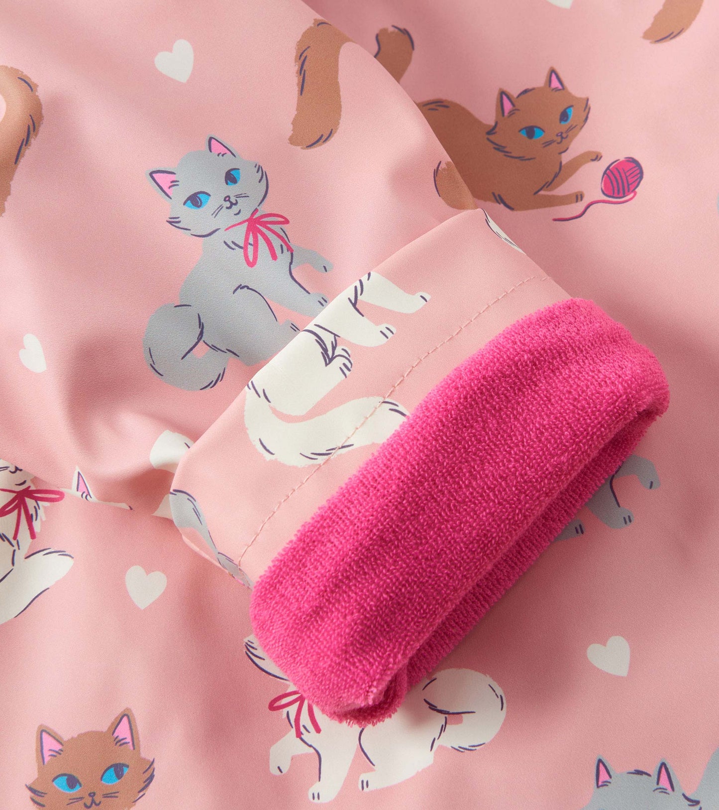 Pink rain jacket featuring playful kitty illustrations and a soft pink cuff. Ideal for baby and toddler girls.