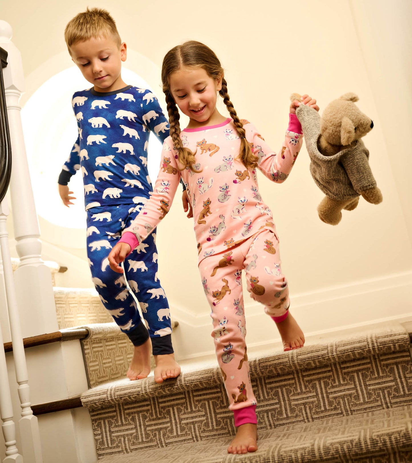 Boys' bamboo pajama set featuring a blue polar bear print and a pink animal pattern, perfect for sleepwear.