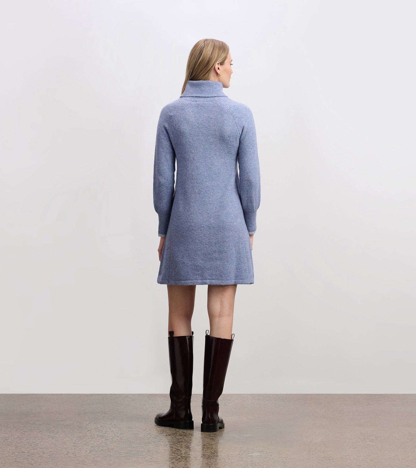 Light denim sweater dress with a high collar and long sleeves, featuring a relaxed fit and above-the-knee length.