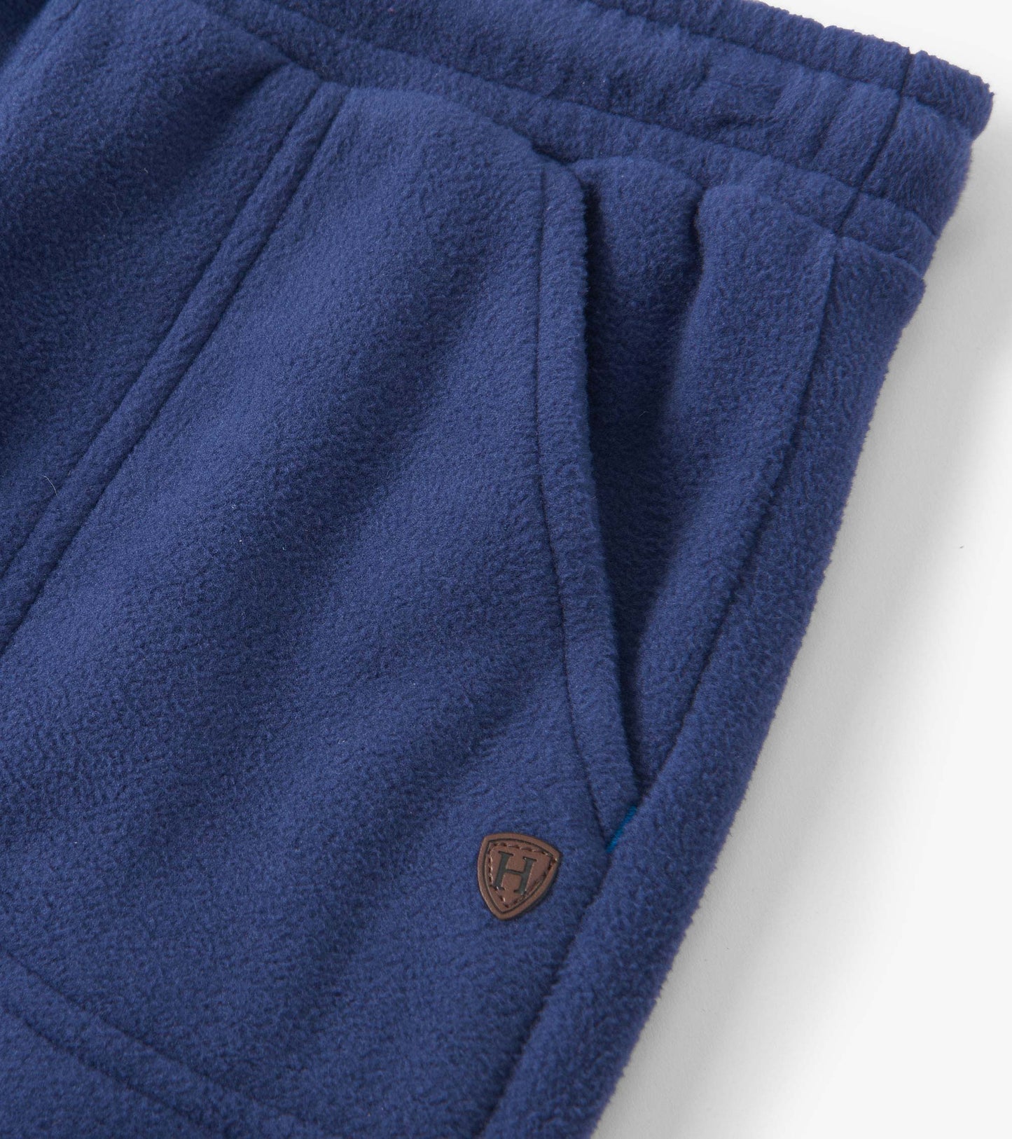 Patriot blue polar fleece joggers featuring side pockets and an elastic waistband for comfort.