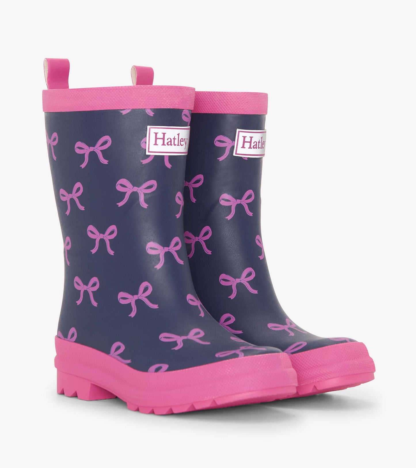 Navy rain boots with pink bows, pink trim, and textured soles, designed for girls.