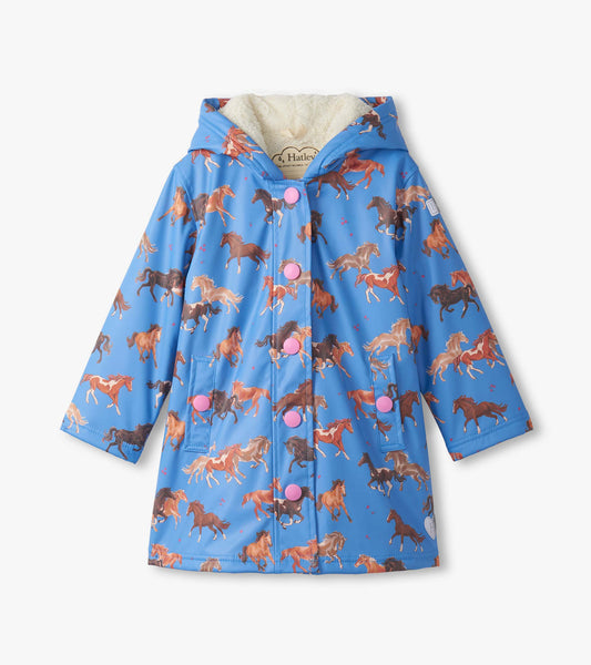 Blue rain jacket featuring a horse print, sherpa lining, and pink buttons, designed for girls.