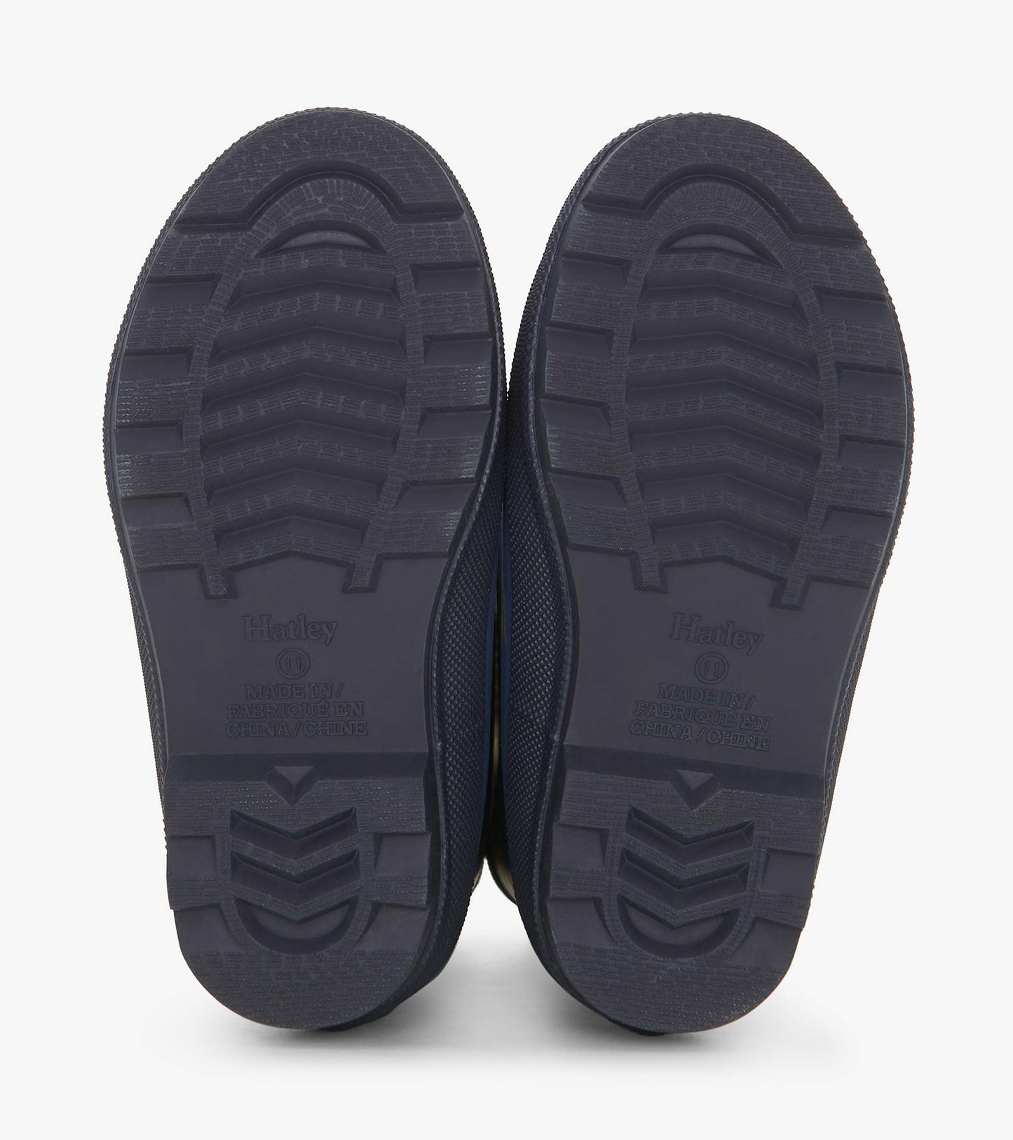 Matte navy rain boots with textured soles, designed for boys, featuring a landscape tractor pattern.