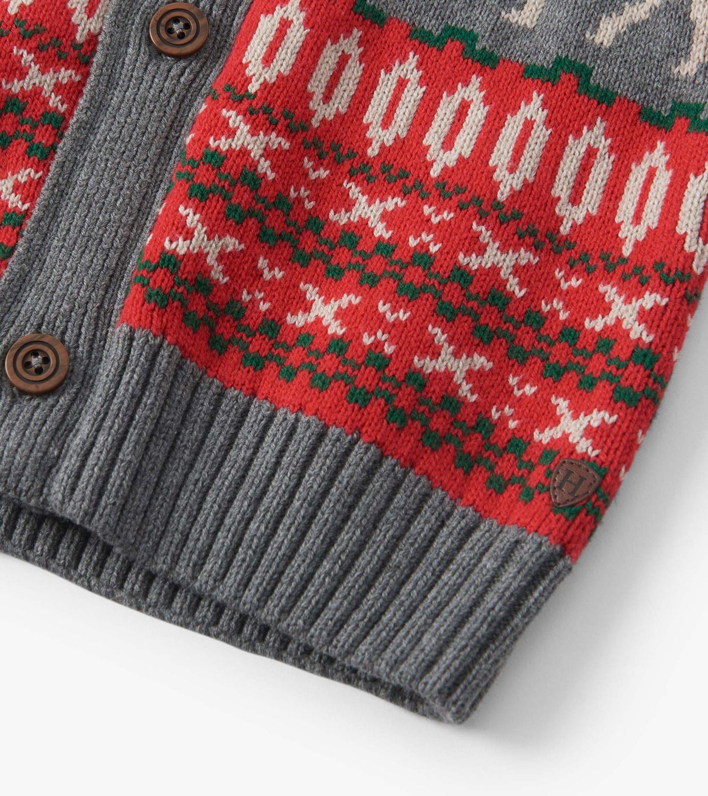 Red and gray knit cardigan featuring elk and geometric patterns, with ribbed cuffs and wooden buttons.