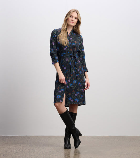 Dark floral midi shirt dress with a tie waist, long sleeves, and a button-down front, paired with knee-high black boots.