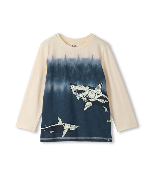 Long sleeve graphic tee featuring a cream and navy design with shark bone illustrations. Soft cotton material.