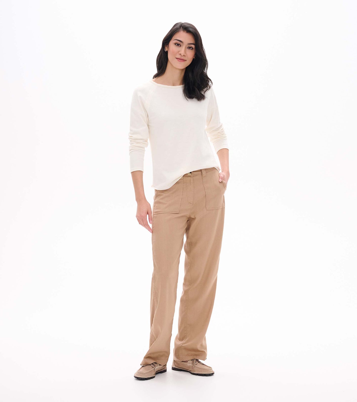 Front view of cream raglan sleeve tee with long sleeves and a curved hem, shown on model