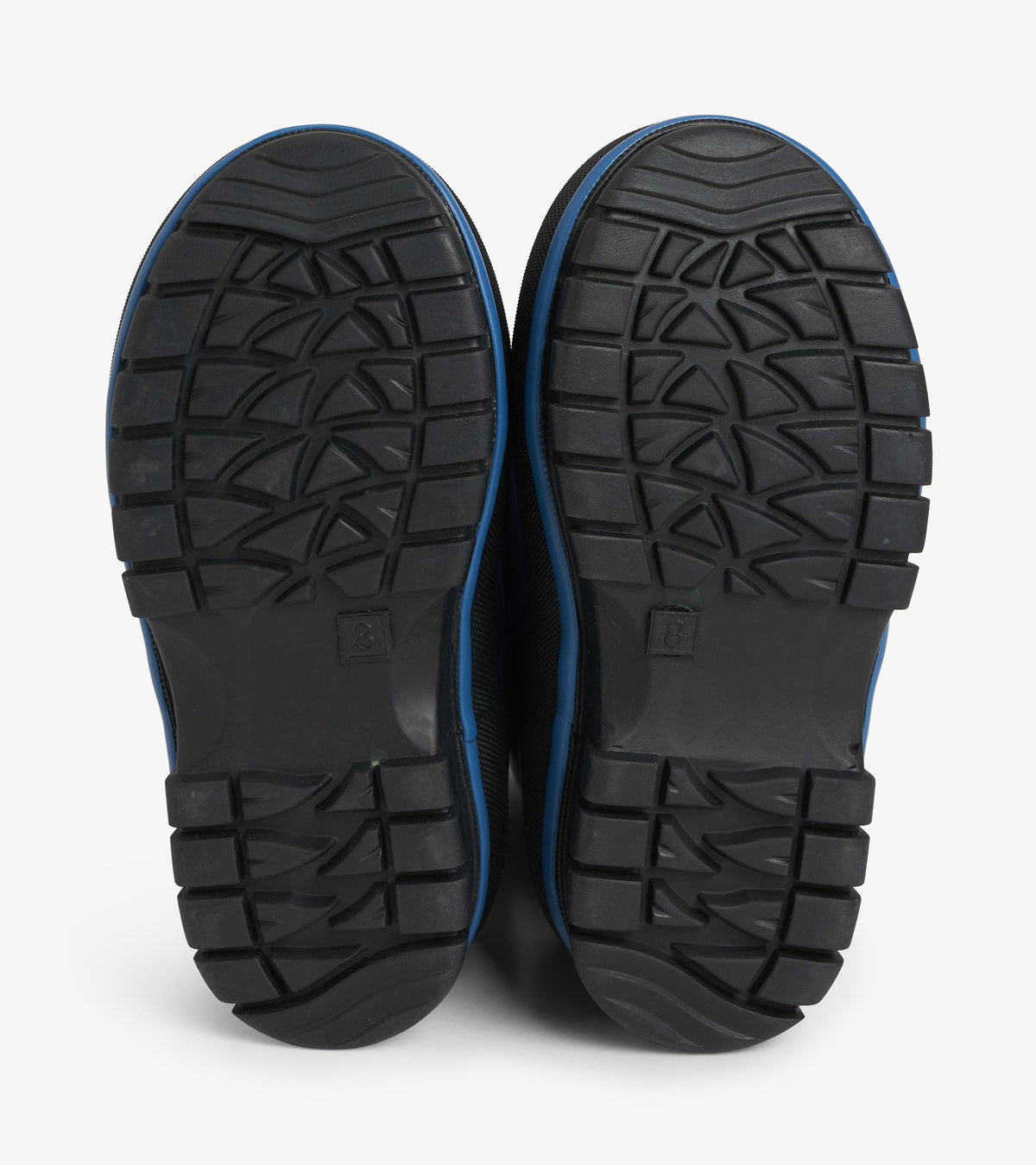 Bottom view of navy kids boots showing black lug outsole tread pattern