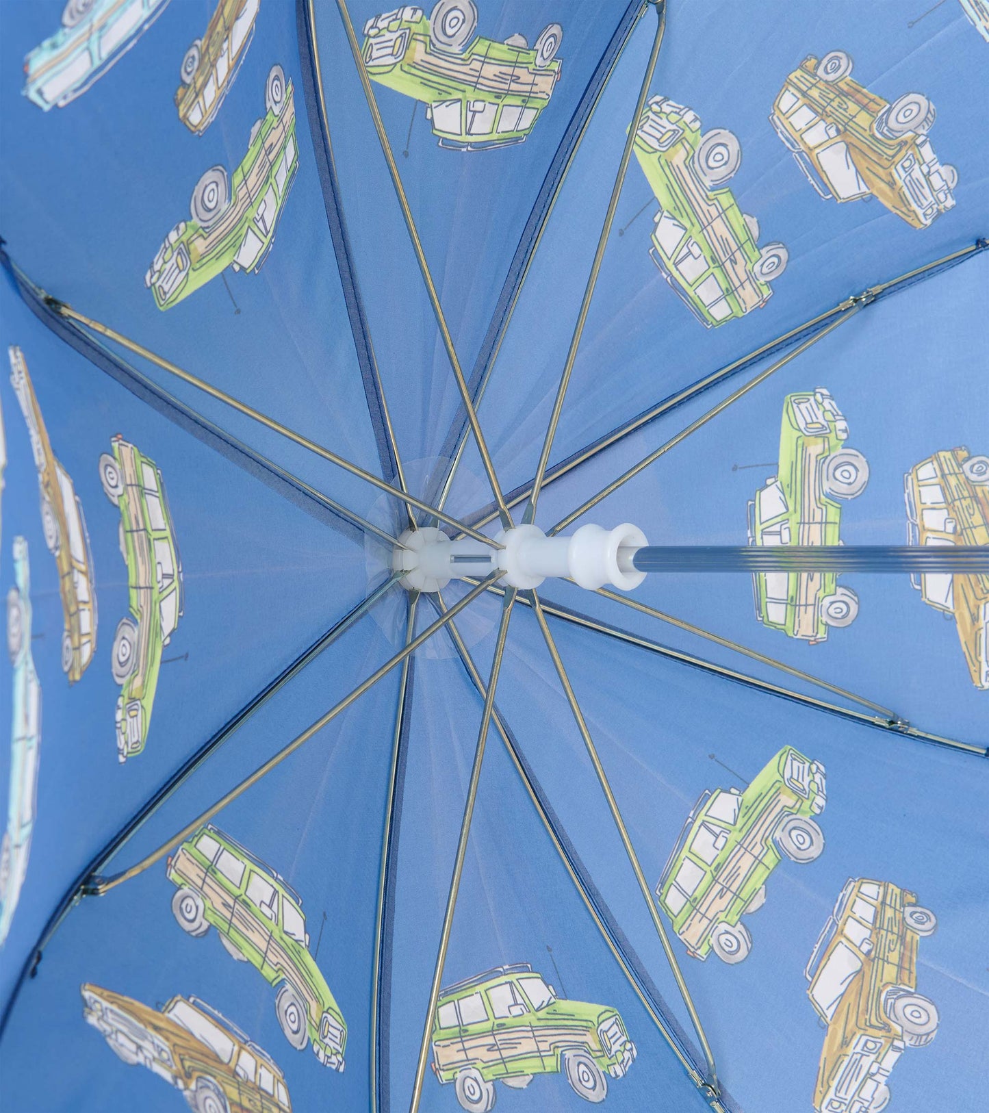 Interior view of blue umbrella showing metal ribs and vintage truck print