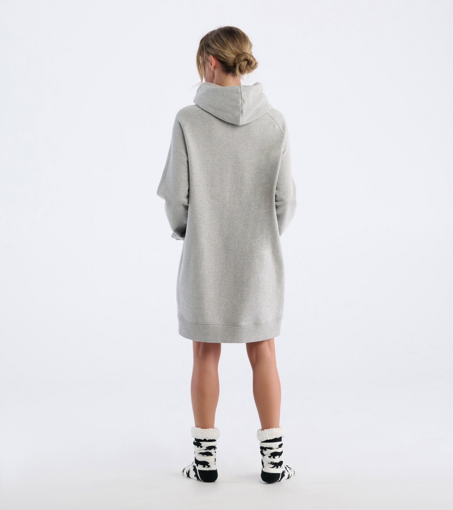 Oversized black hoodie with a cozy fit, featuring a hood and long sleeves, styled with black and white patterned socks.