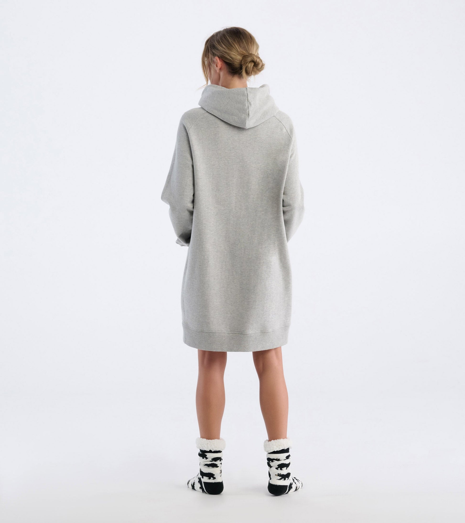 Oversized black hoodie with a cozy fit, featuring a hood and long sleeves, styled with black and white patterned socks.