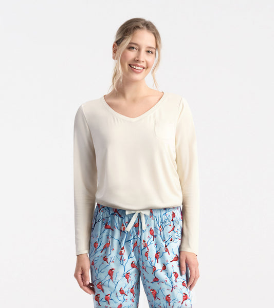Cream long sleeve t-shirt with a v-neck and pocket, paired with patterned blue pajama pants.