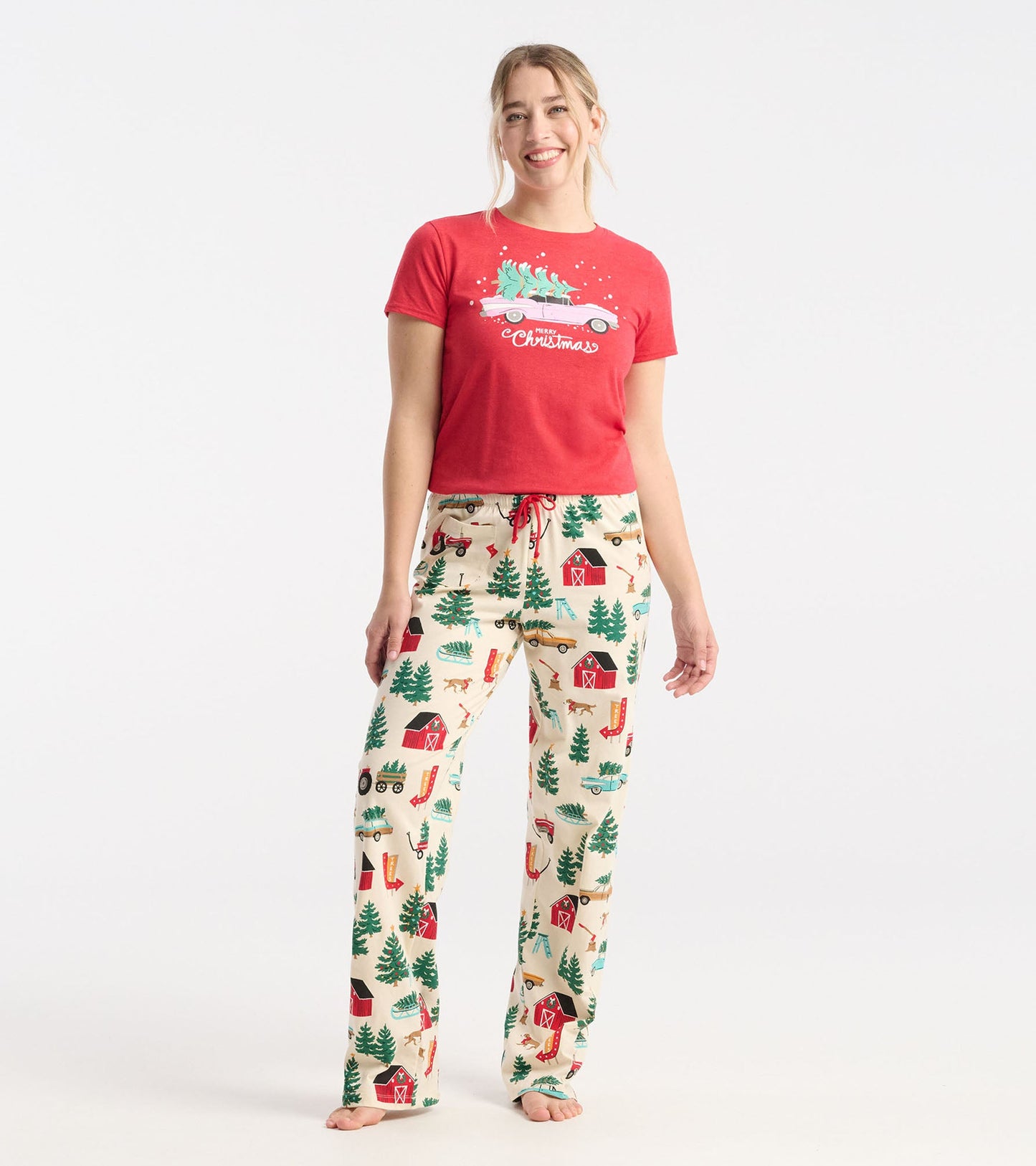 Cream cotton pajama pants with a festive Christmas tree farm print, featuring red drawstring and relaxed fit.