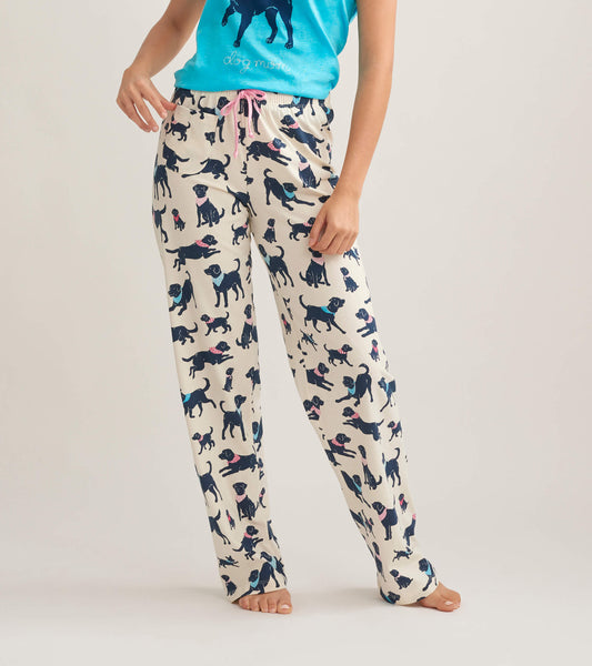 Women's cotton pajama pants featuring a playful dog print in navy on a cream background, with a pink drawstring waist.
