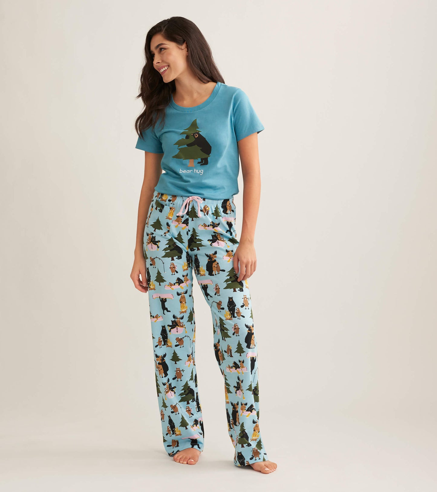 Light blue cotton pajama pants featuring a playful animal and tree pattern, paired with a matching graphic tee.