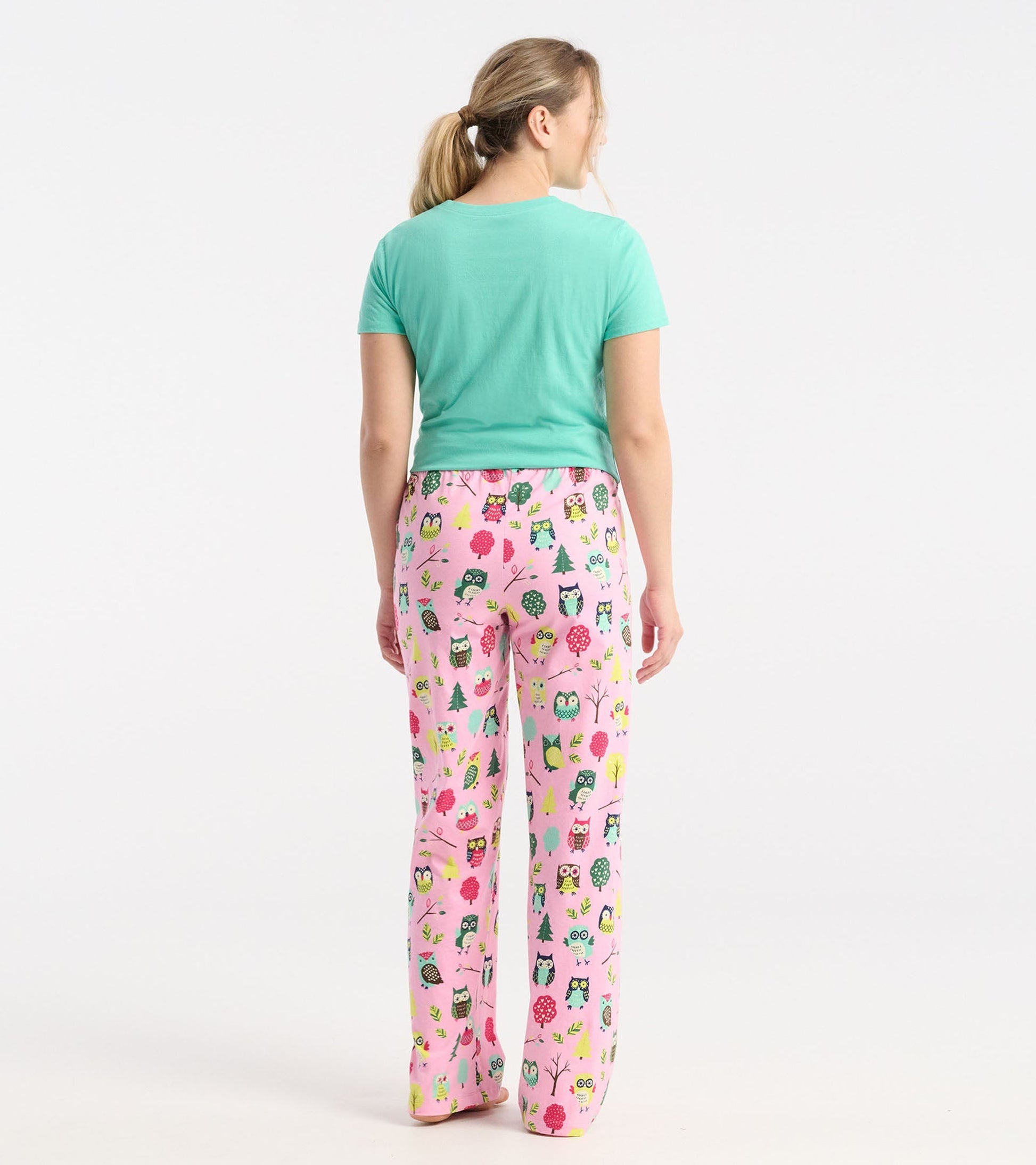 Pink cotton pajama pants featuring a playful owl and tree pattern, styled with a relaxed fit for comfort.