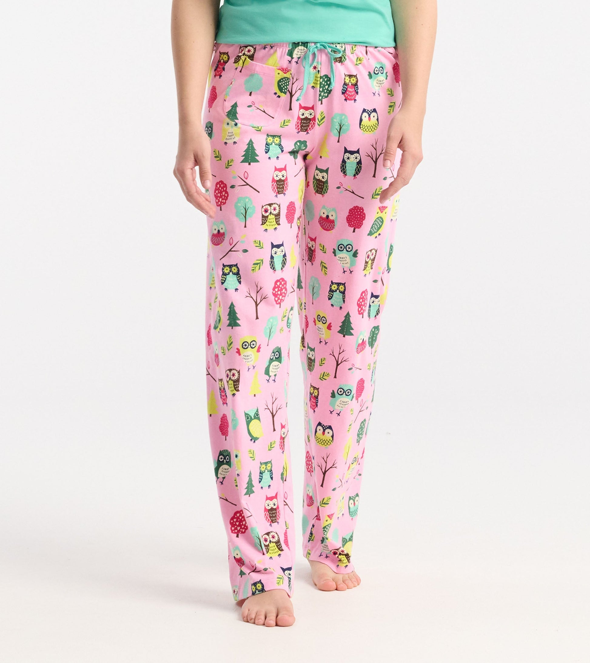 Pink cotton pajama pants featuring a playful owl and tree pattern, with an elastic waistband and drawstring.