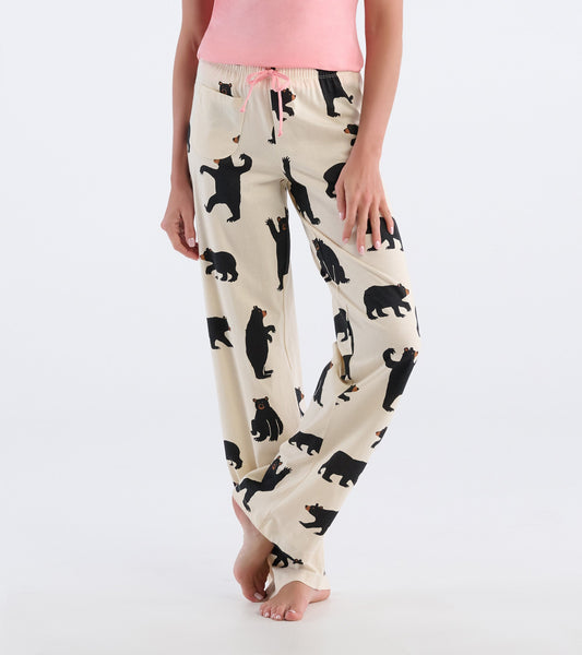 Cream cotton pajama pants featuring a playful black bear pattern, with an elastic waistband and drawstring.
