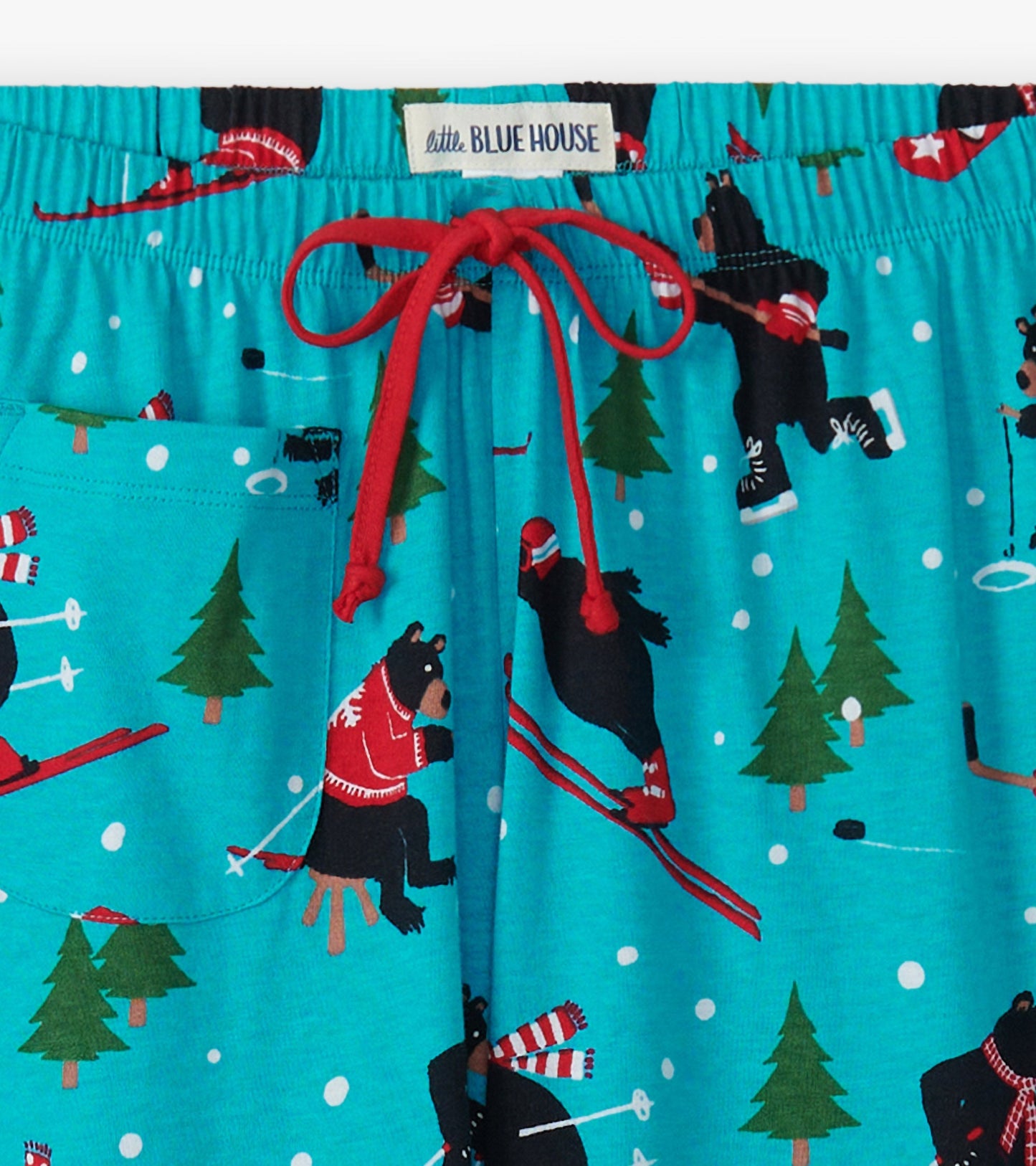 Turquoise cotton pajama pants featuring playful bear skiing patterns, red drawstring, and side pocket.
