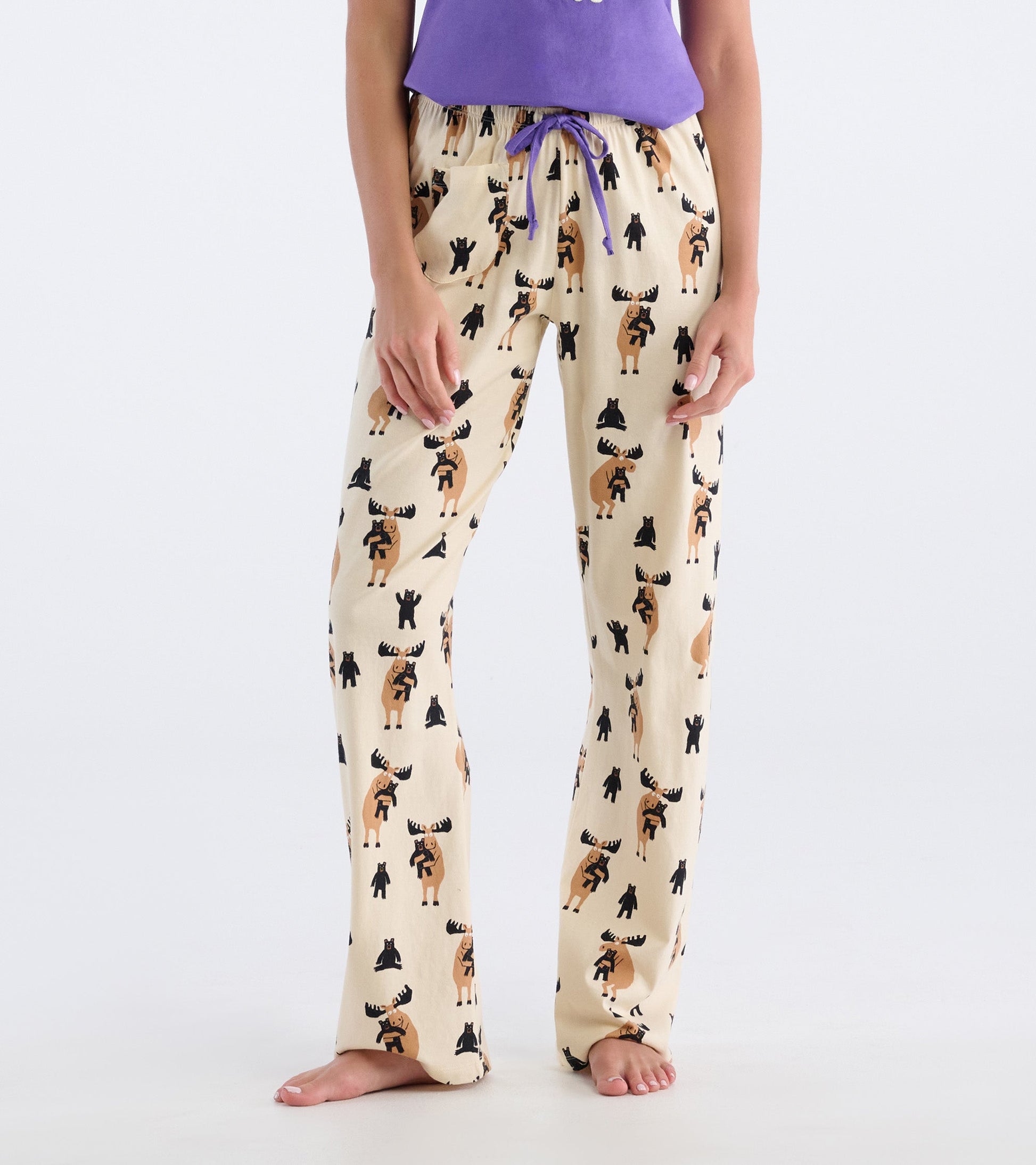Cream cotton pajama pants featuring a playful moose and bear pattern, with an elastic waistband and drawstring.