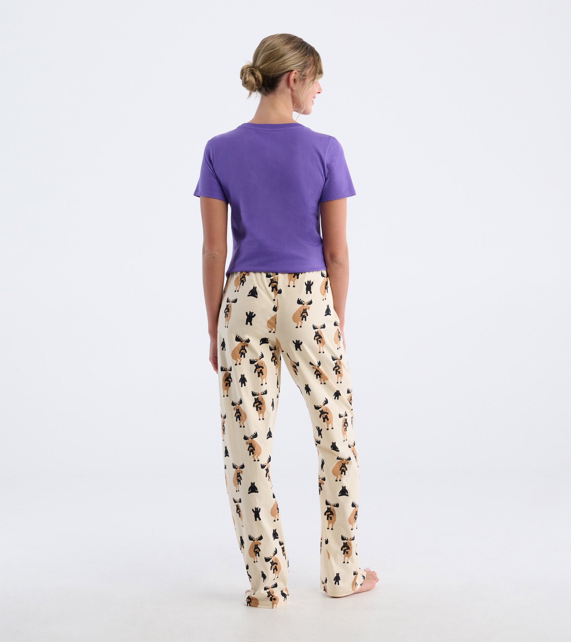 Cream cotton pajama pants featuring a playful moose and bear pattern, styled for comfort and relaxation.