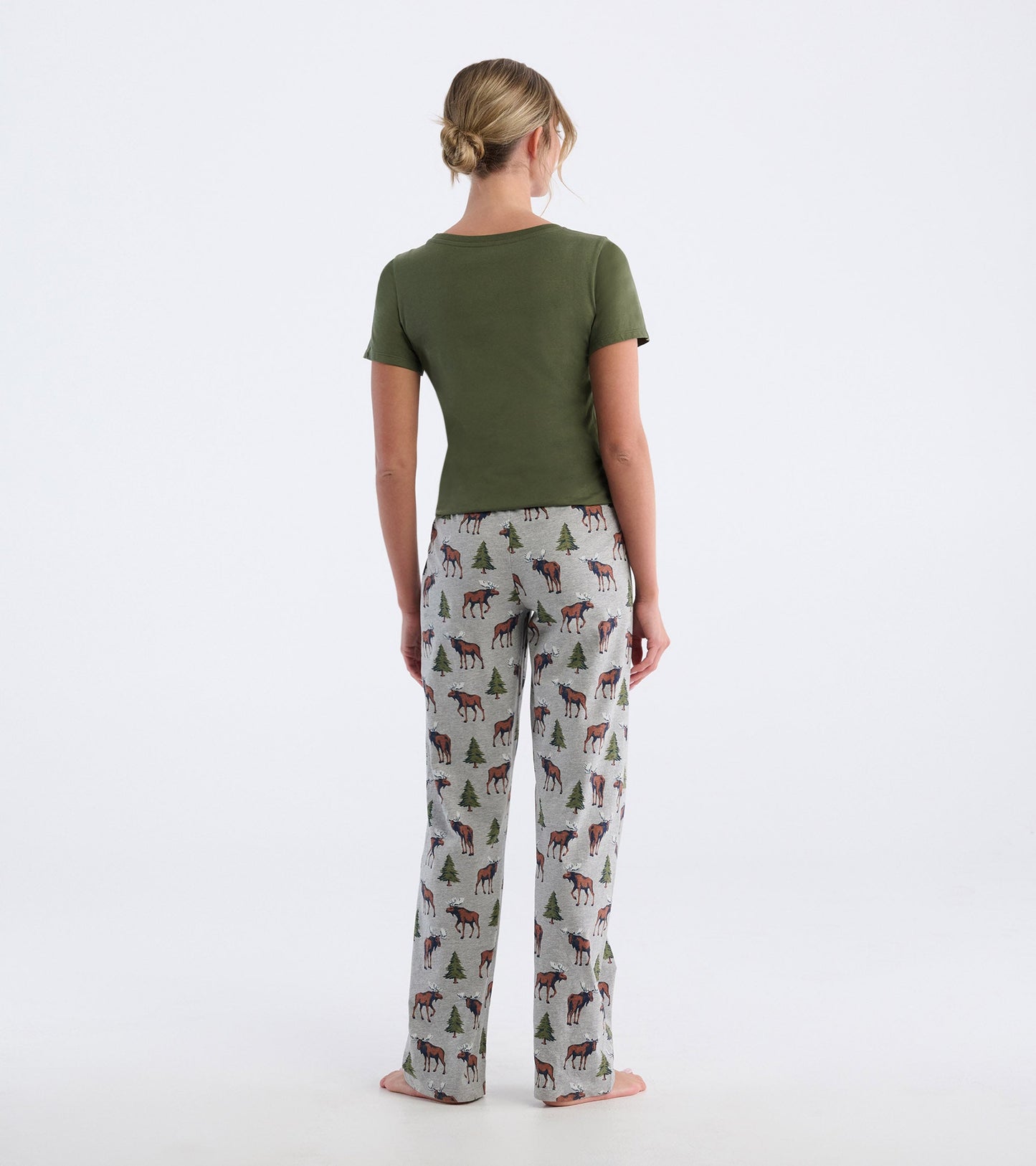Cotton blend pajama pants featuring a moose and tree pattern, shown from the back with a green top.