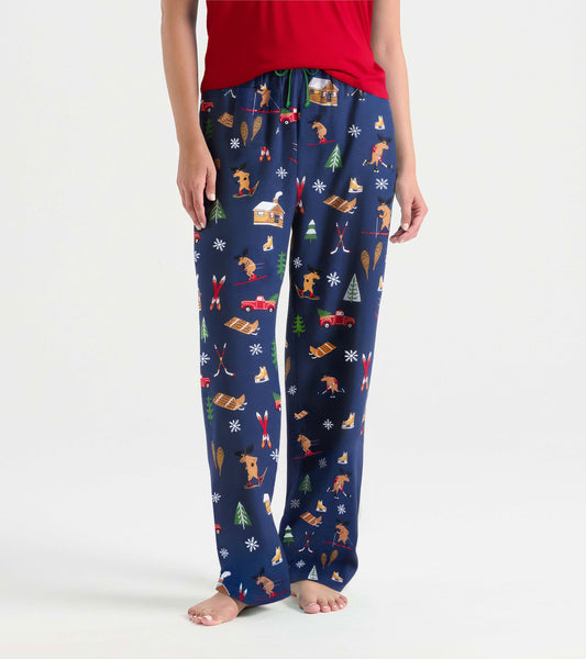 Navy cotton pajama pants featuring a winter cabin print with animals, trees, and snowflakes, ideal for cozy lounging.