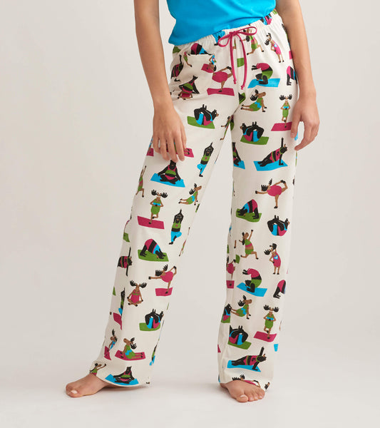 White cotton pajama pants featuring colorful yoga-themed animal prints, with an elastic waistband and drawstring.