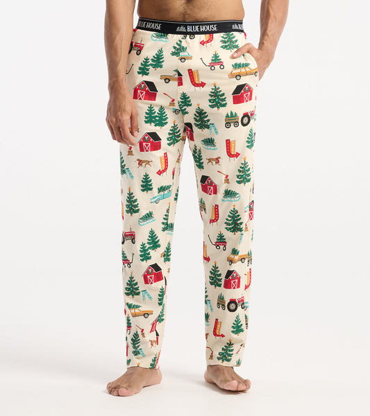 Cream cotton pajama pants featuring a festive Christmas tree farm print with barns, trees, and tractors.