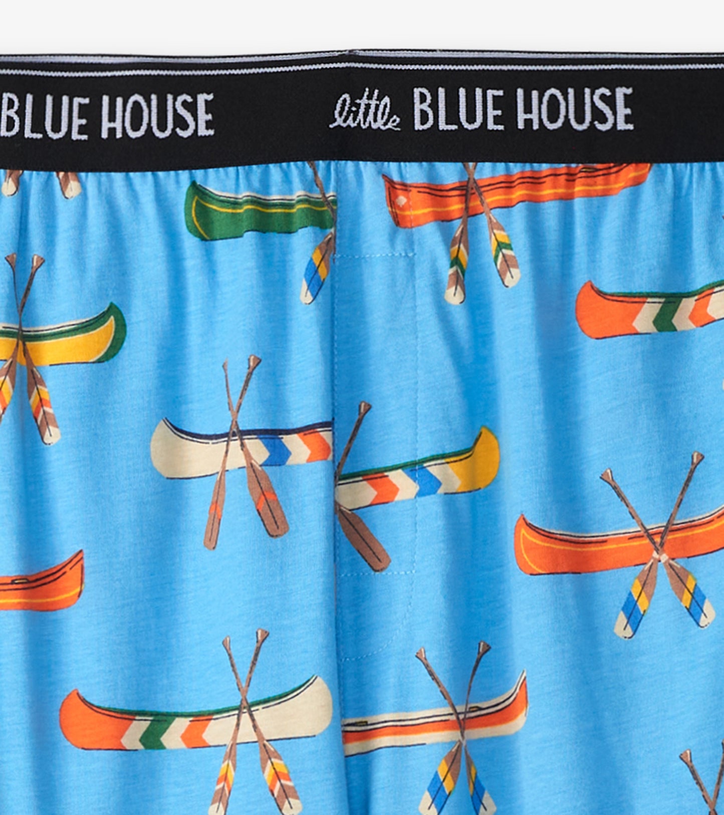 Close-up of blue pajama pants with colorful canoe and paddle print and Little Blue House waistband