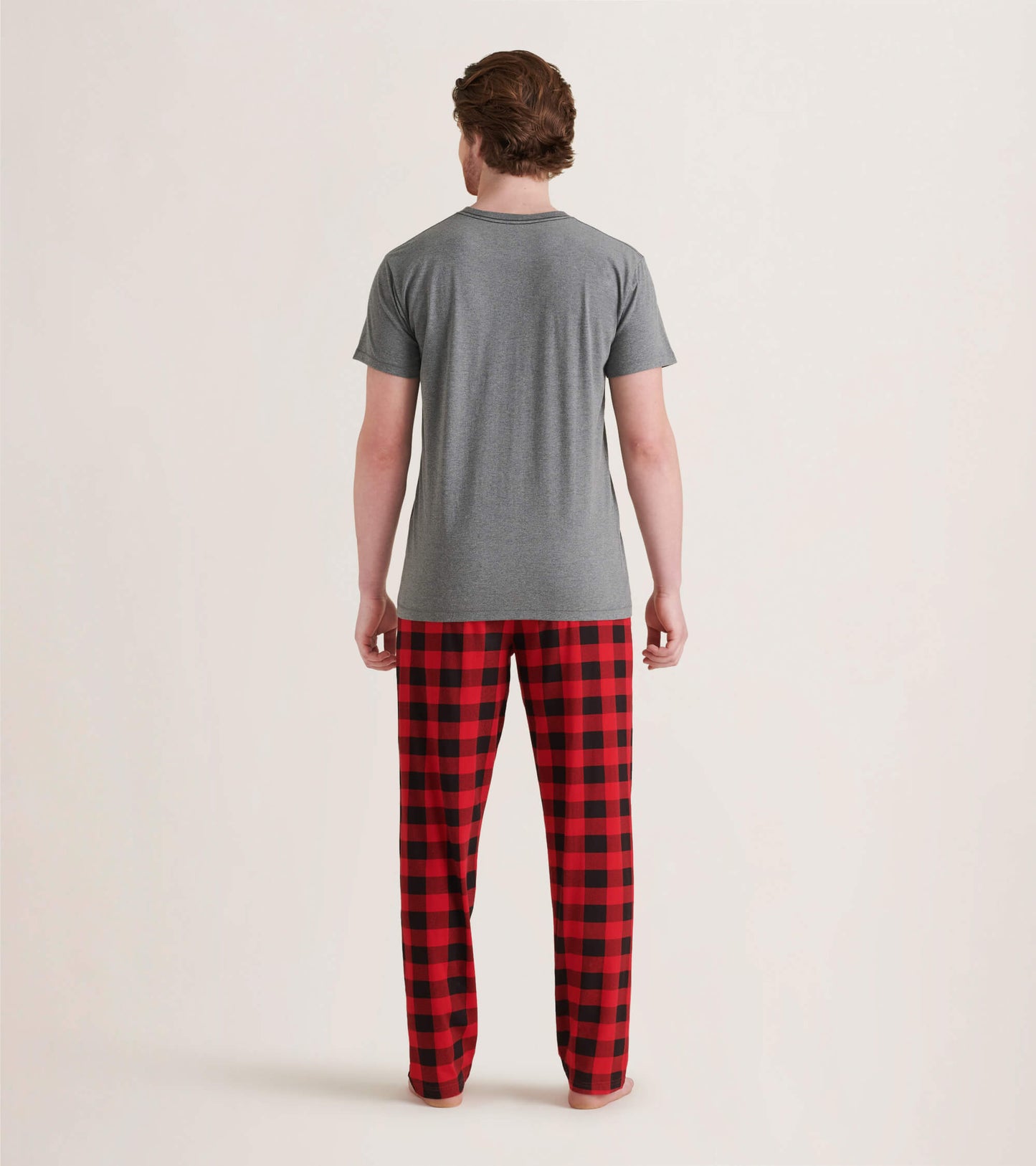 Men's pajama pants in red and black buffalo plaid pattern, made of stretch cotton, shown from the back.