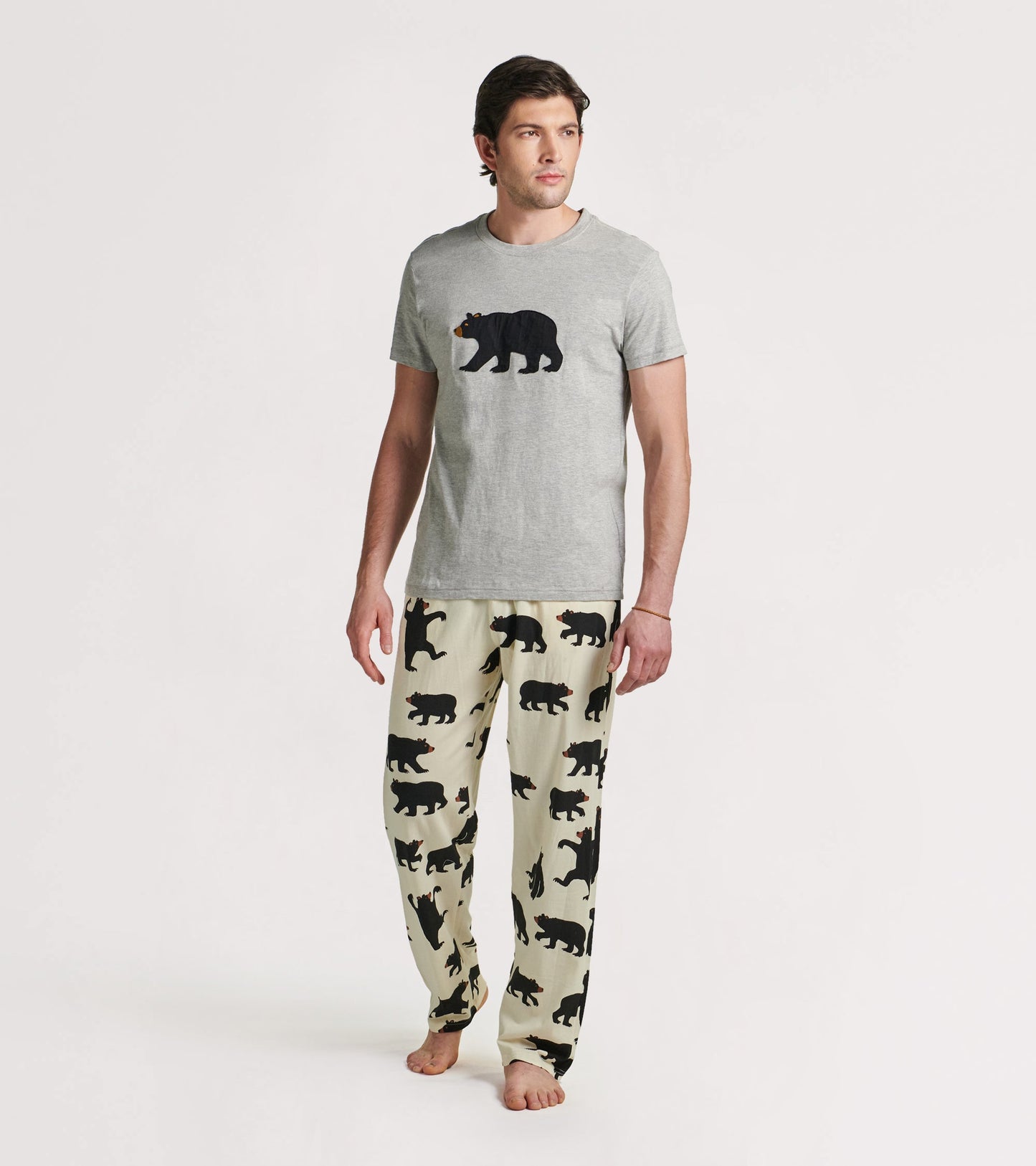 Men's pajama pants in cream with black bear silhouettes, made of stretch cotton for comfort.