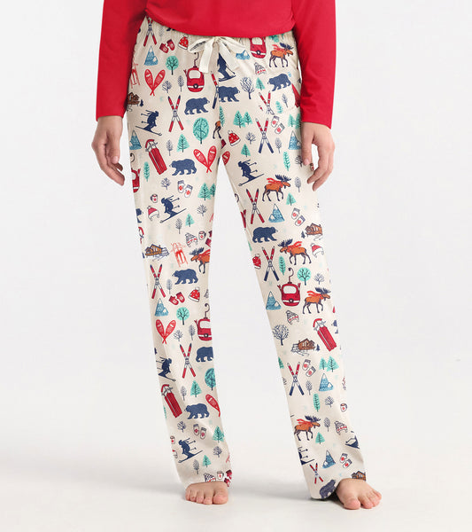Cream pajama pants featuring a colorful vintage ski and wildlife pattern, with an elastic waistband and drawstring.