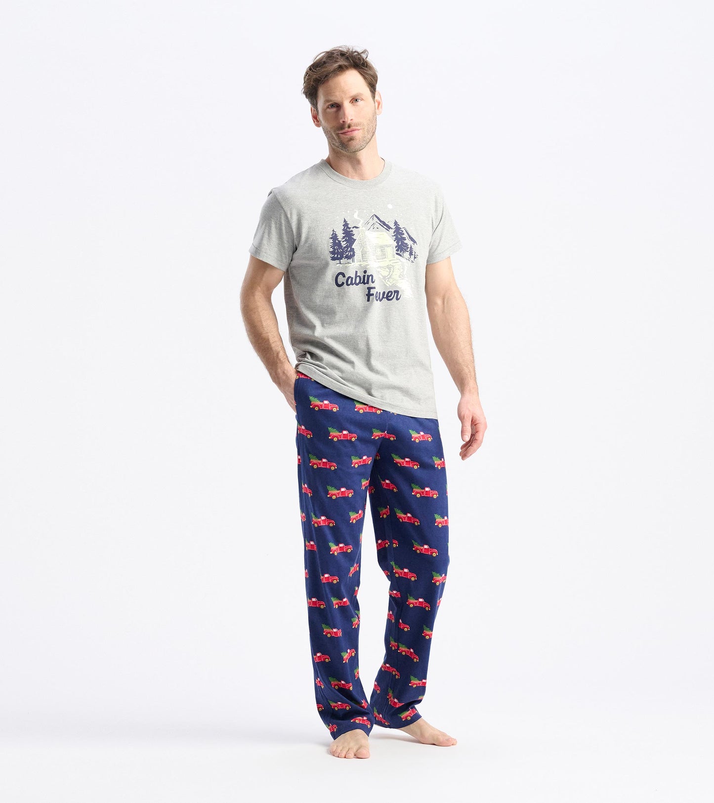 Men's pajama pants featuring a navy background with red truck patterns, paired with a light gray graphic t-shirt.