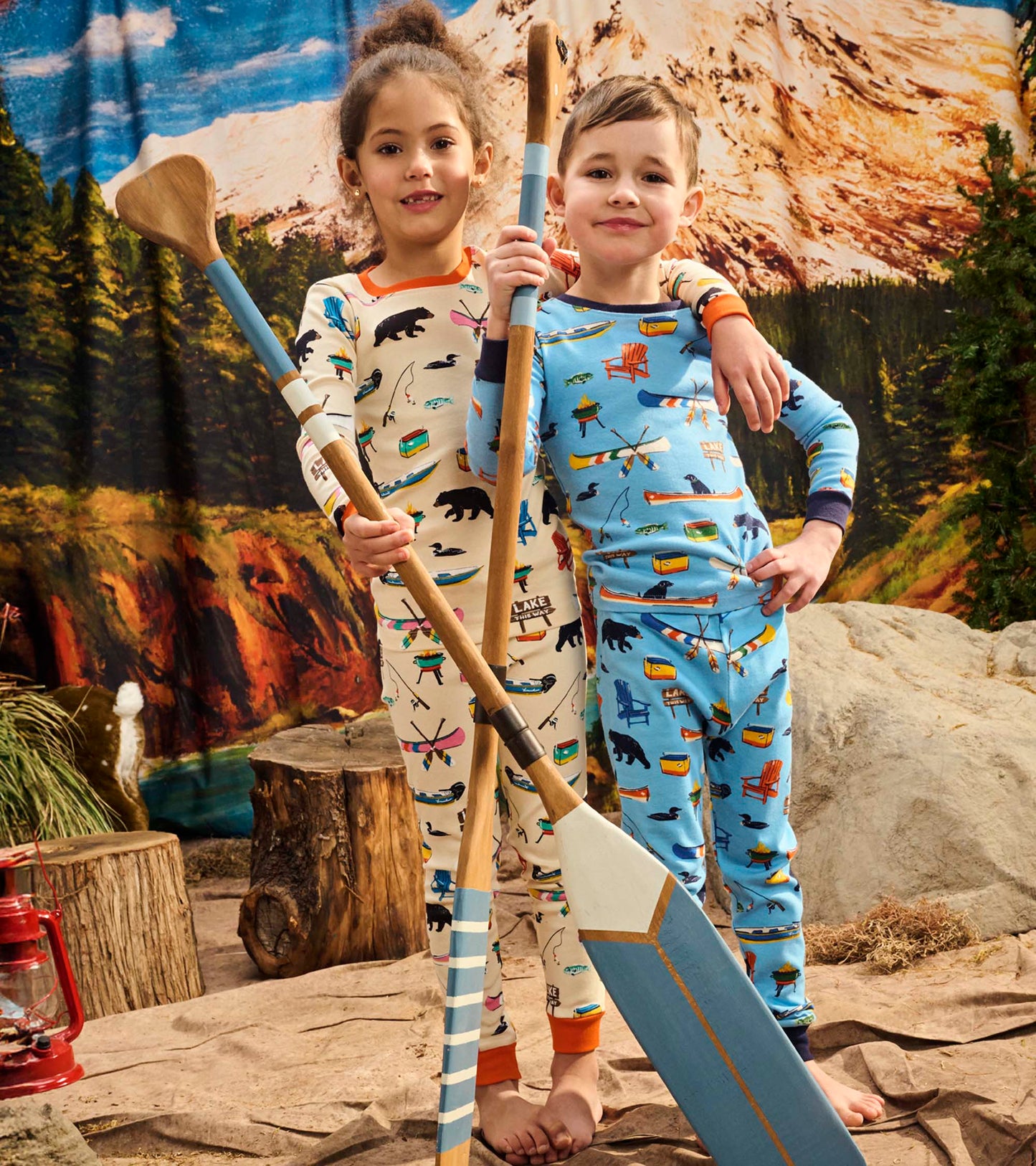 Kids' pajama set featuring blue and cream patterns with bears and canoes, perfect for cozy sleepwear.