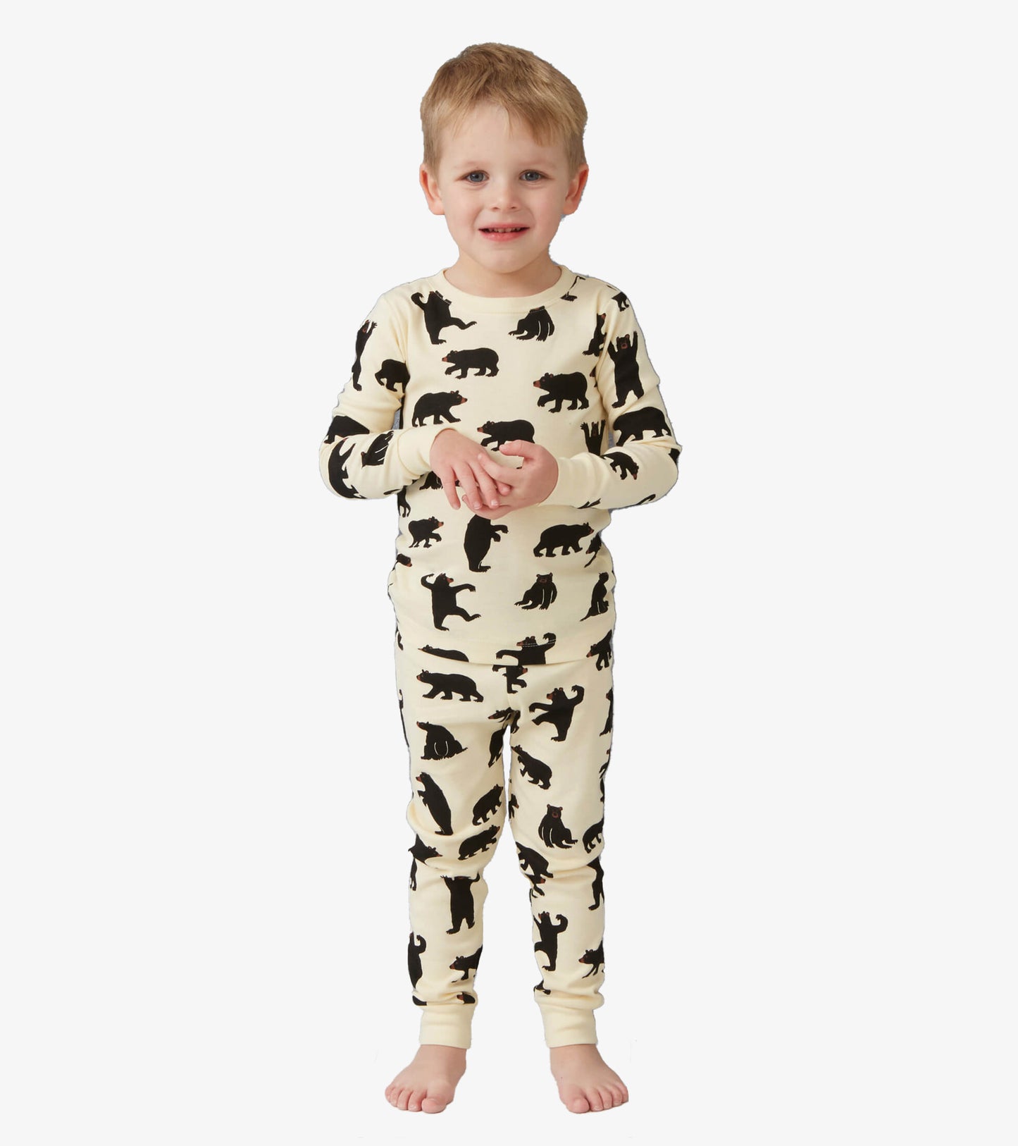 Cream-colored kids' pajama set featuring black bear silhouettes, long sleeves, and matching pants.