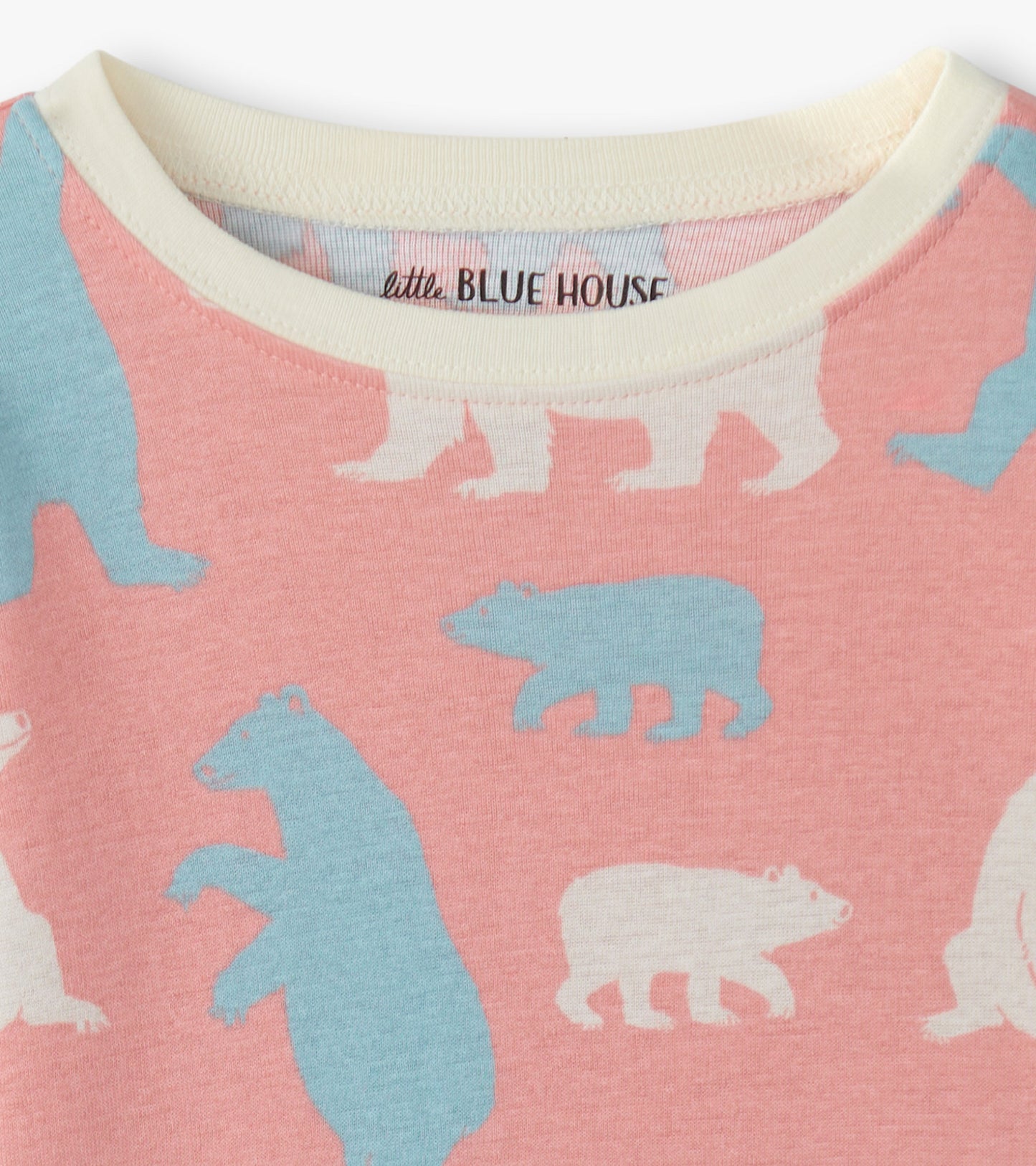 Pink pajama set featuring playful polar bear patterns in blue and white, made from soft, comfortable fabric.