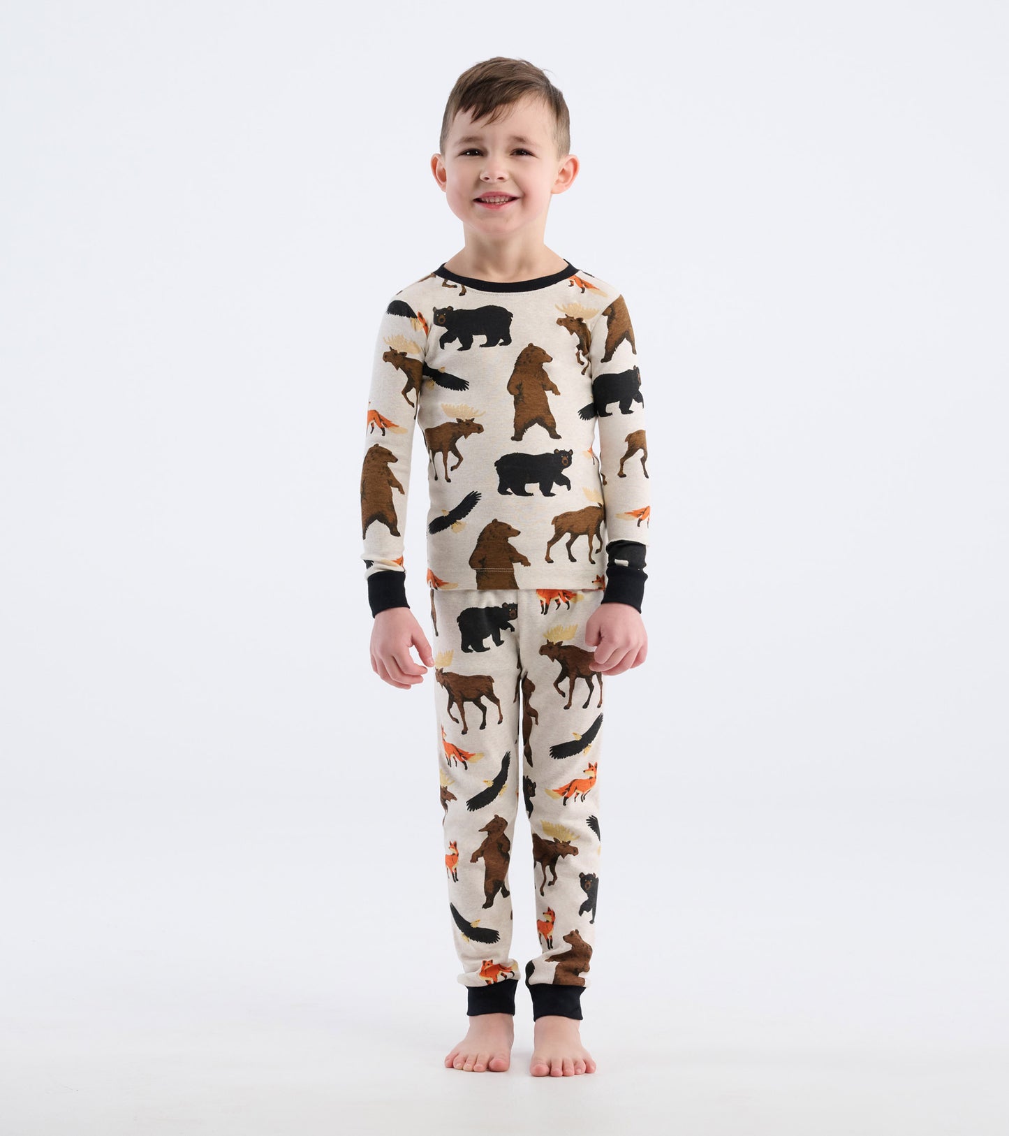 Kids' pajama set featuring a cream base with colorful animal prints, including bears and foxes, in a snug fit.