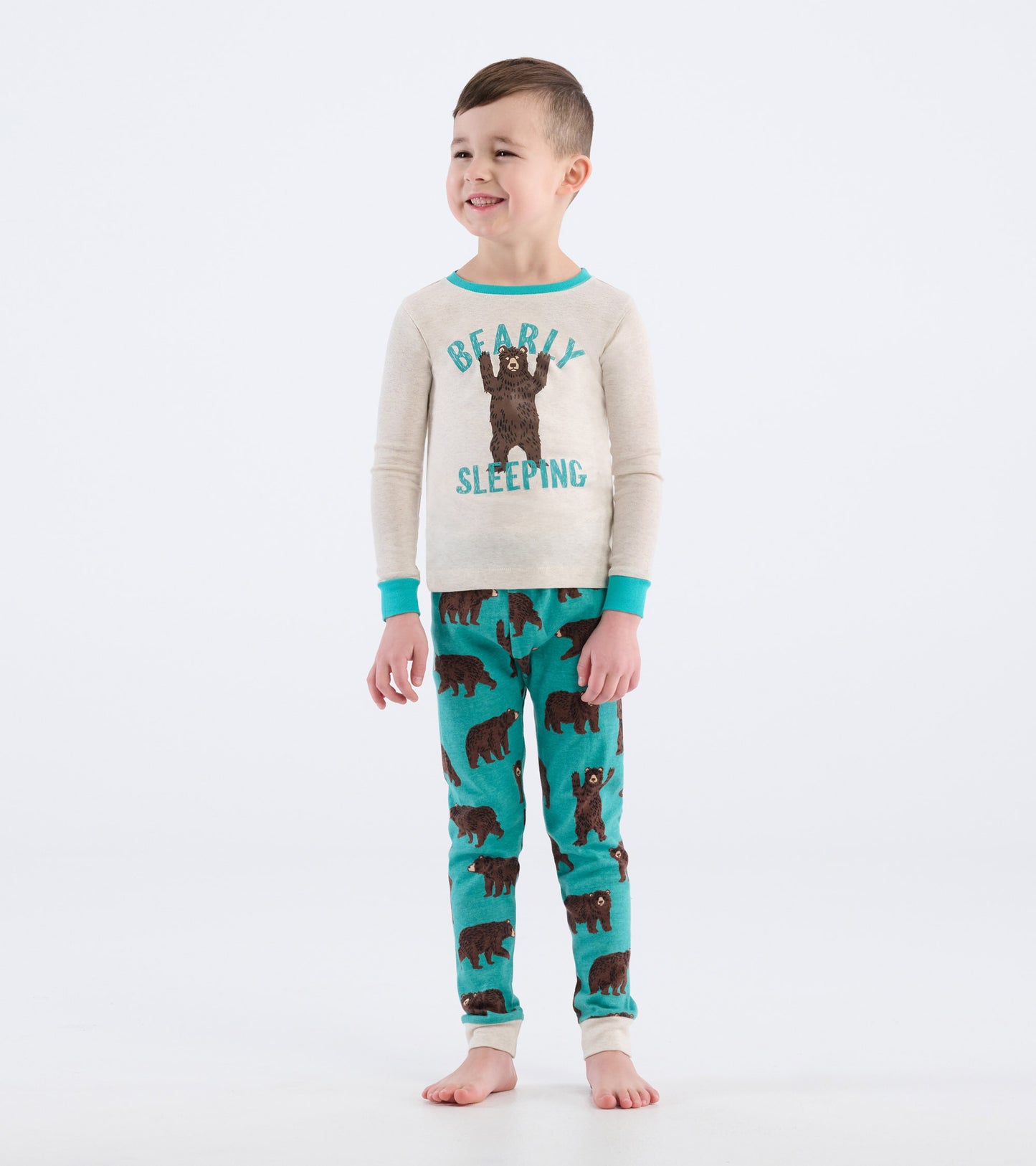 Tan long-sleeve top with bear graphic and turquoise accents, paired with turquoise pants featuring brown bear prints.