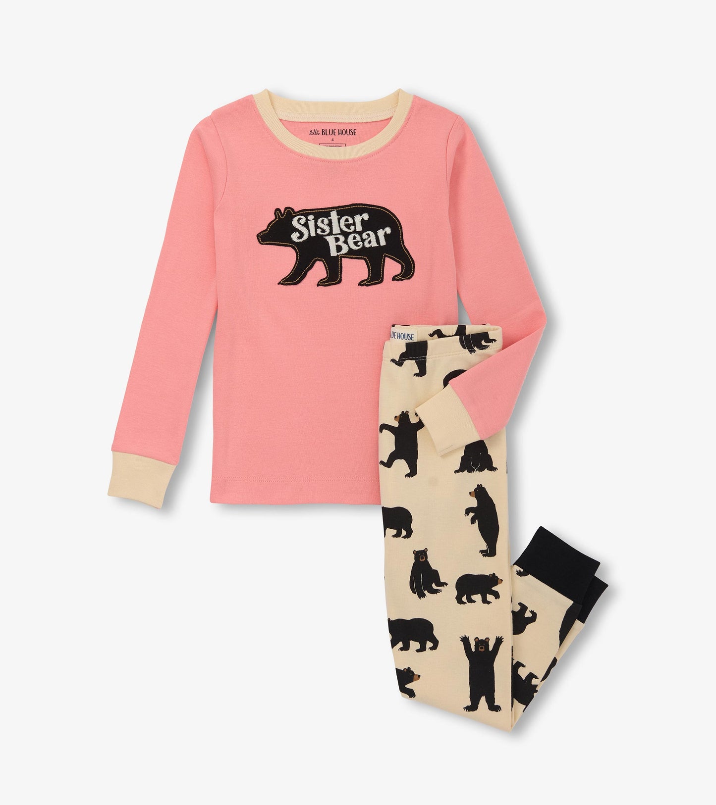 Pink long-sleeve top with "Sister Bear" graphic and cream cuffs, paired with beige pants featuring black bear prints.