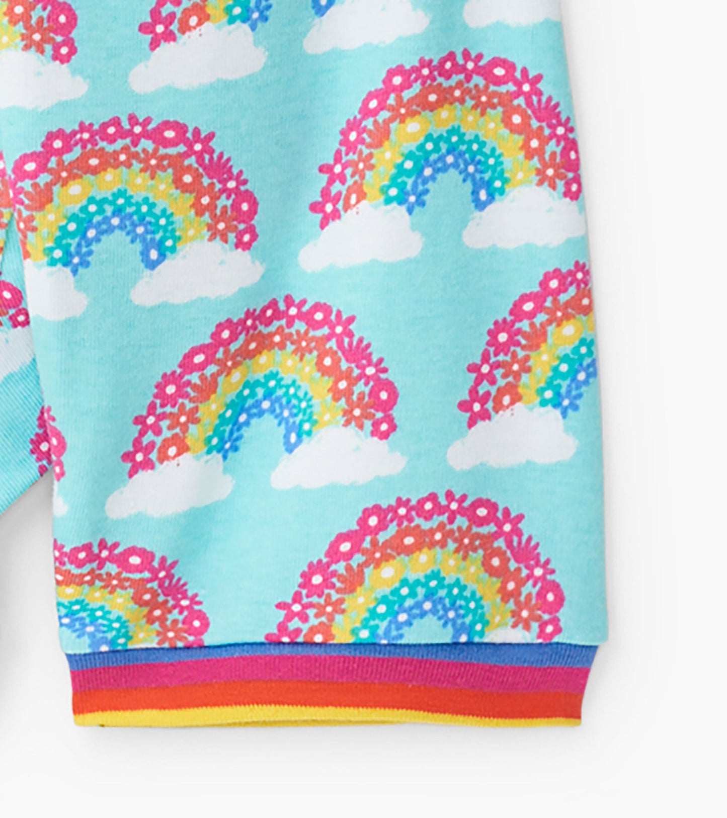 Light blue organic cotton pajama set featuring colorful rainbows and flowers, with striped cuffs.