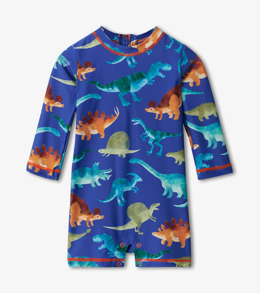 Blue one-piece rashguard featuring colorful dinosaur patterns, long sleeves, and snap closures at the bottom.