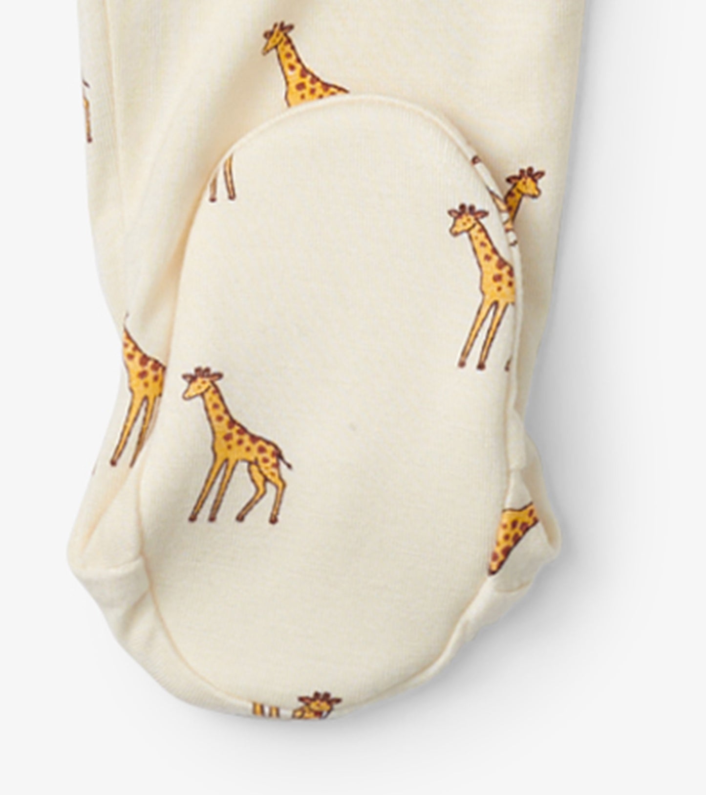 Cream footed sleeper featuring playful giraffe prints, designed for baby boys. Soft fabric for comfort and warmth.